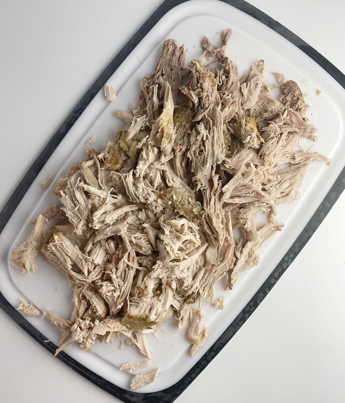 Shredded pork on a cutting board.