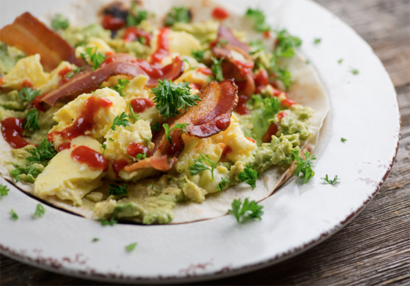 Crispy bacon, soft scrambled egg, velvety avocado and Sriracha nestle on a warmed tortilla in this breakfast tacos recipe that is perfect any time of day!