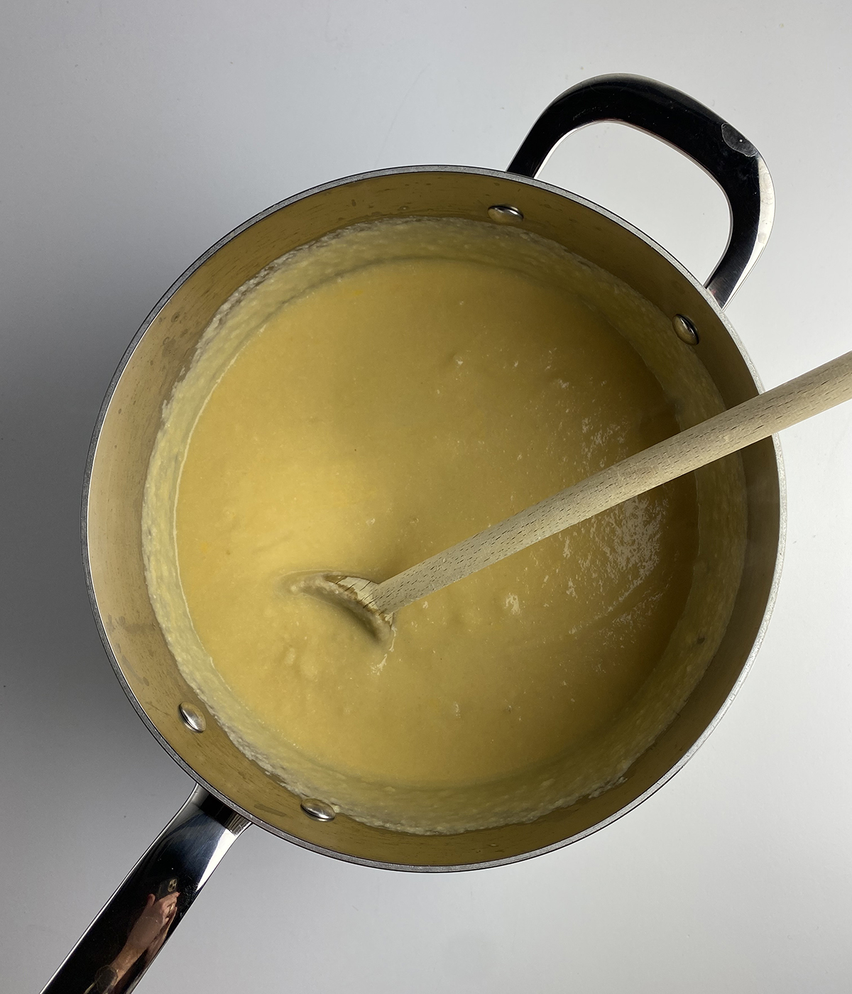 Cheesy cauliflower soup in a pot.