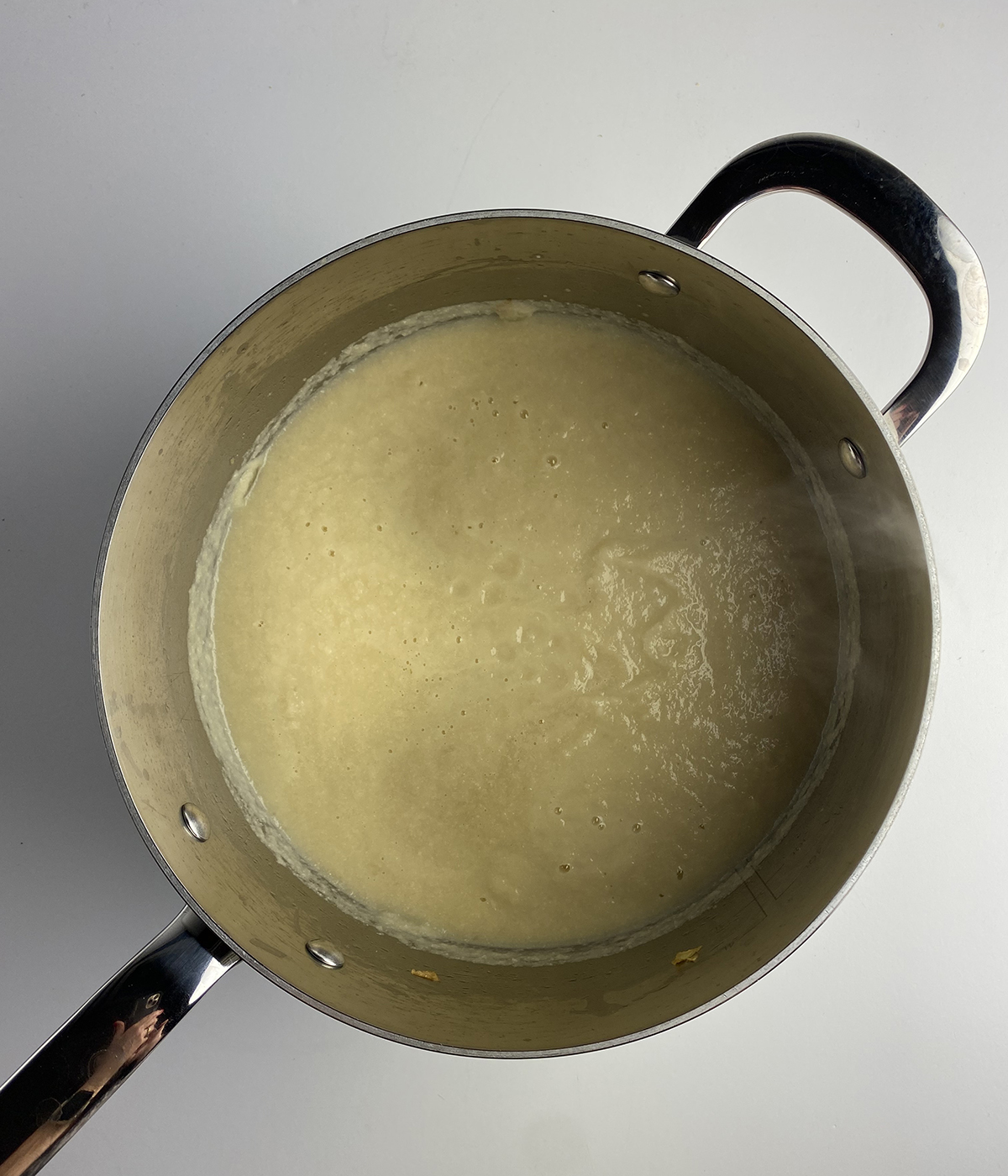 Pureed cauliflower soup in a pot.