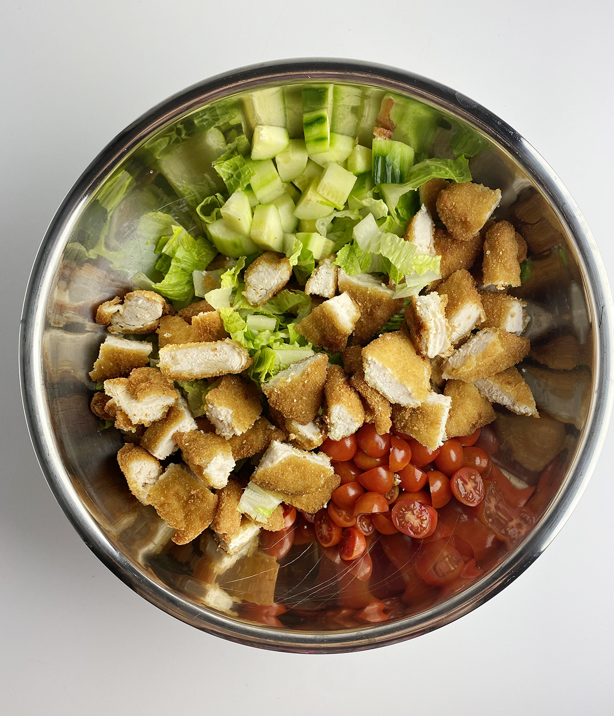 Fried chicken salad ingredients in a bowl.