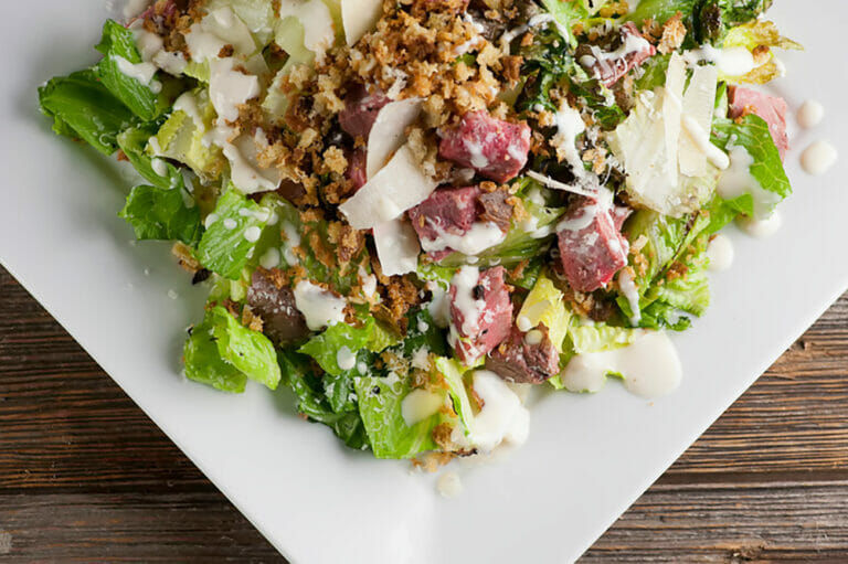 The best steak Caesar salad on a plate.