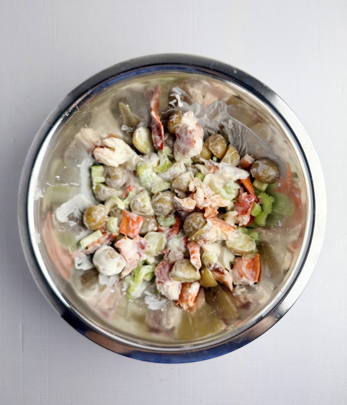 Lobster potato salad in a mixing bowl.