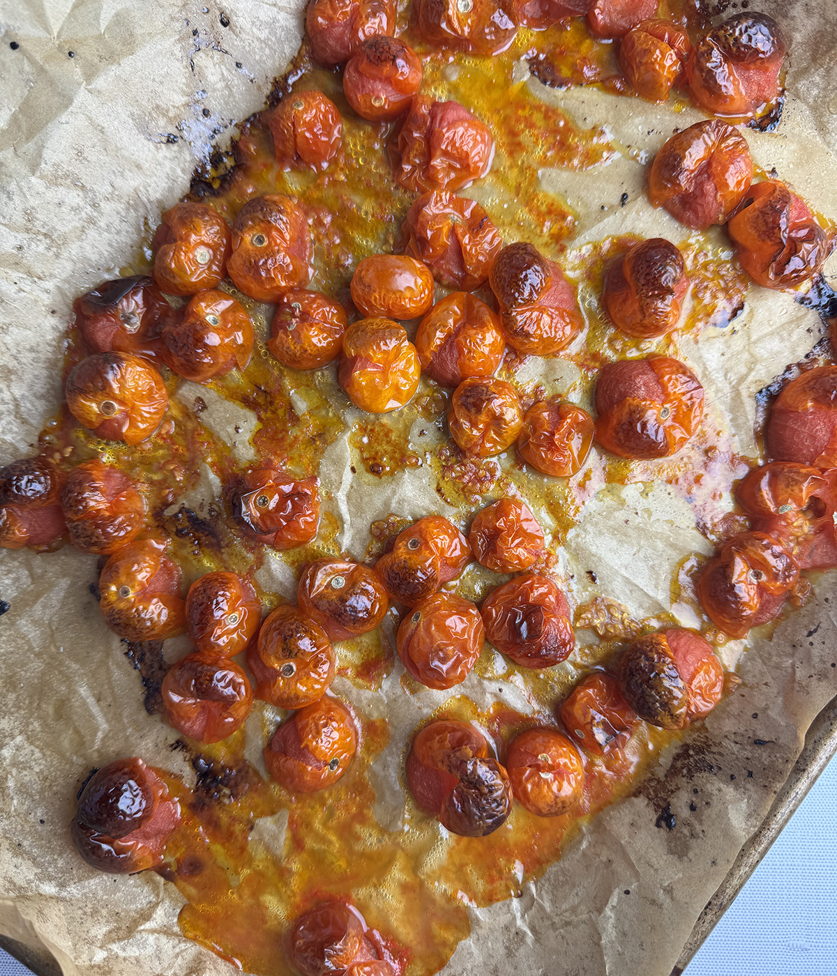 Roasted cherry tomatoes ona baking sheet.