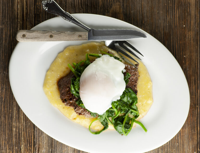 Steak eggs and spinach on a plate.