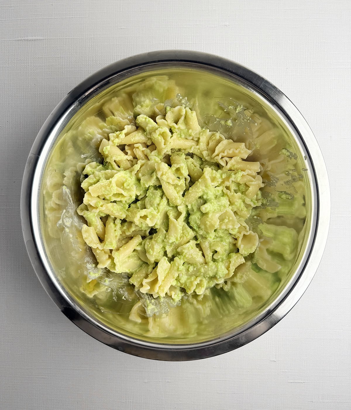 Bowl of pasta tossed with edamame sauce.