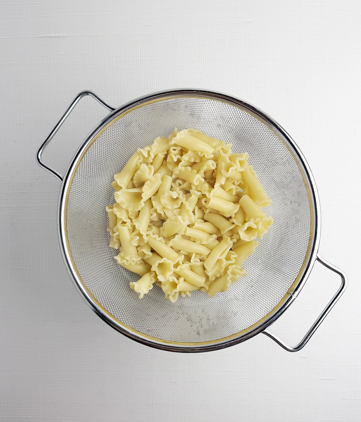 Short pasta in a strainer.