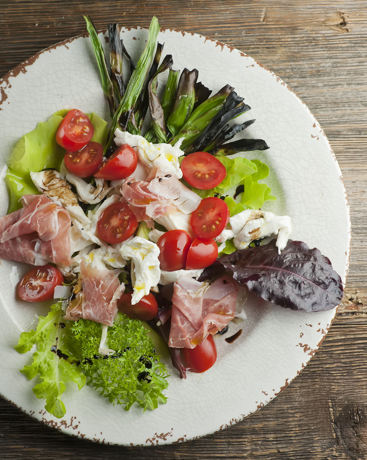 Summer Prosciutto Caprese Salad on a plate.