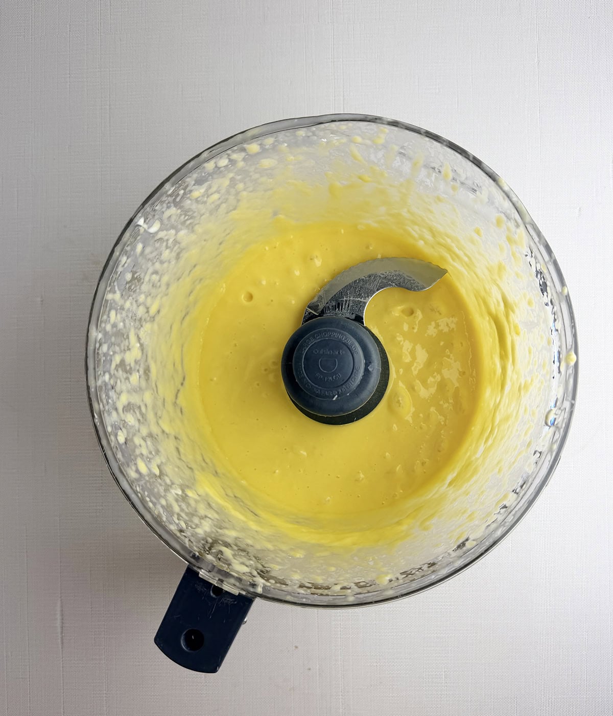Mango dressing in a food processor.