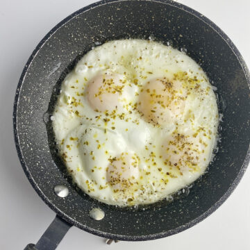 Perfect fried eggs cooked in a skillet.