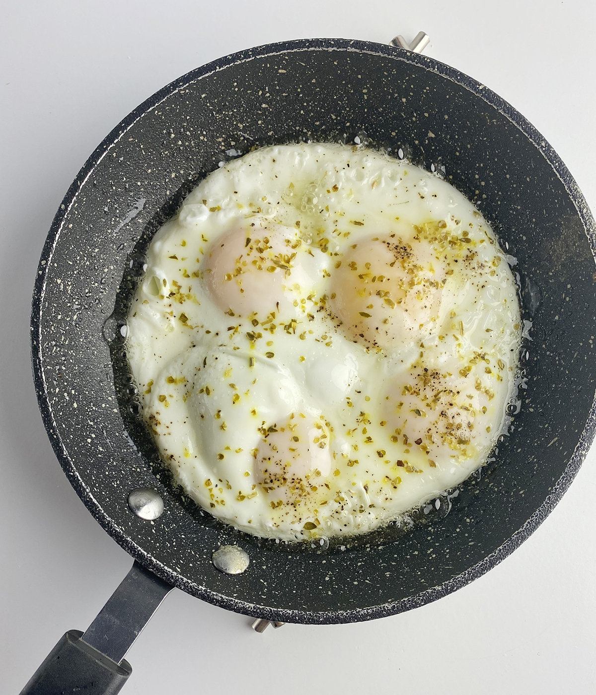 Perfect fried eggs cooked in a skillet.