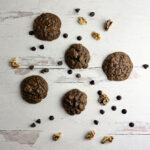 Brownie cookies and chocolate chips on a wooden board..