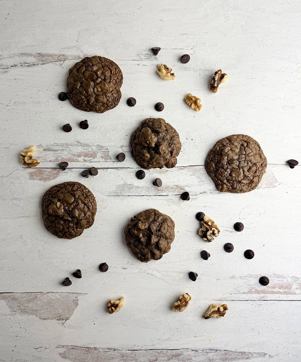 Brownie cookies and chocolate chips on a wooden board..