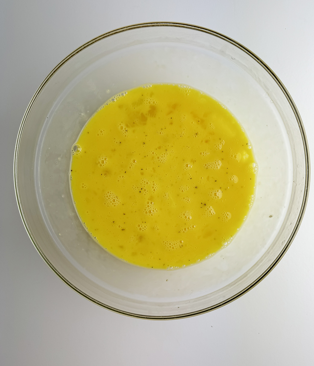 Mixing bowl with beaten eggs.