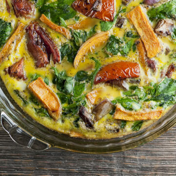 Roasted vegetable frittata in a pie plate.