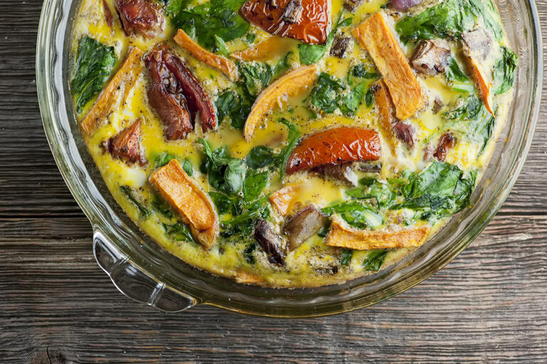 Roasted vegetable frittata in a pie plate.