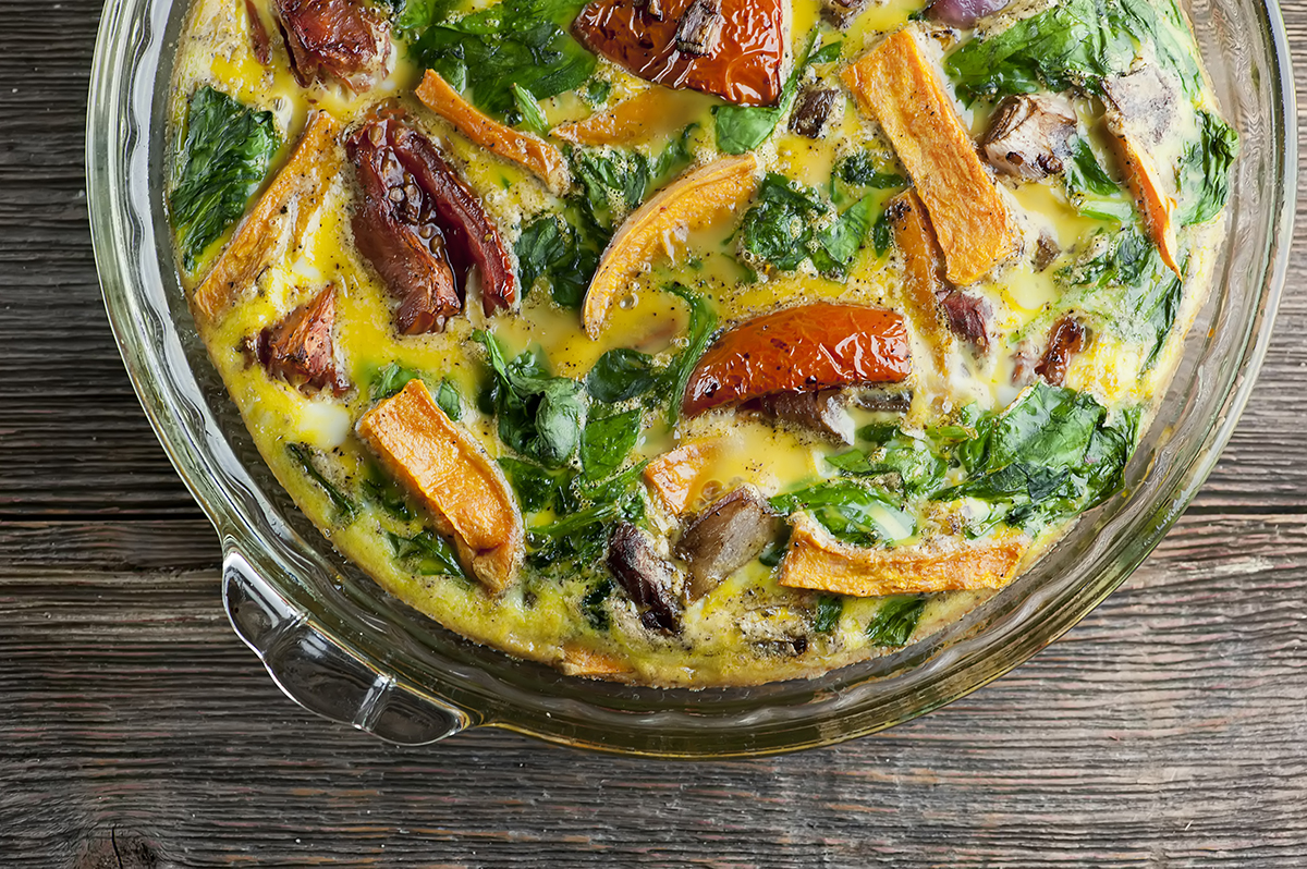 Roasted vegetable frittata in a pie plate.