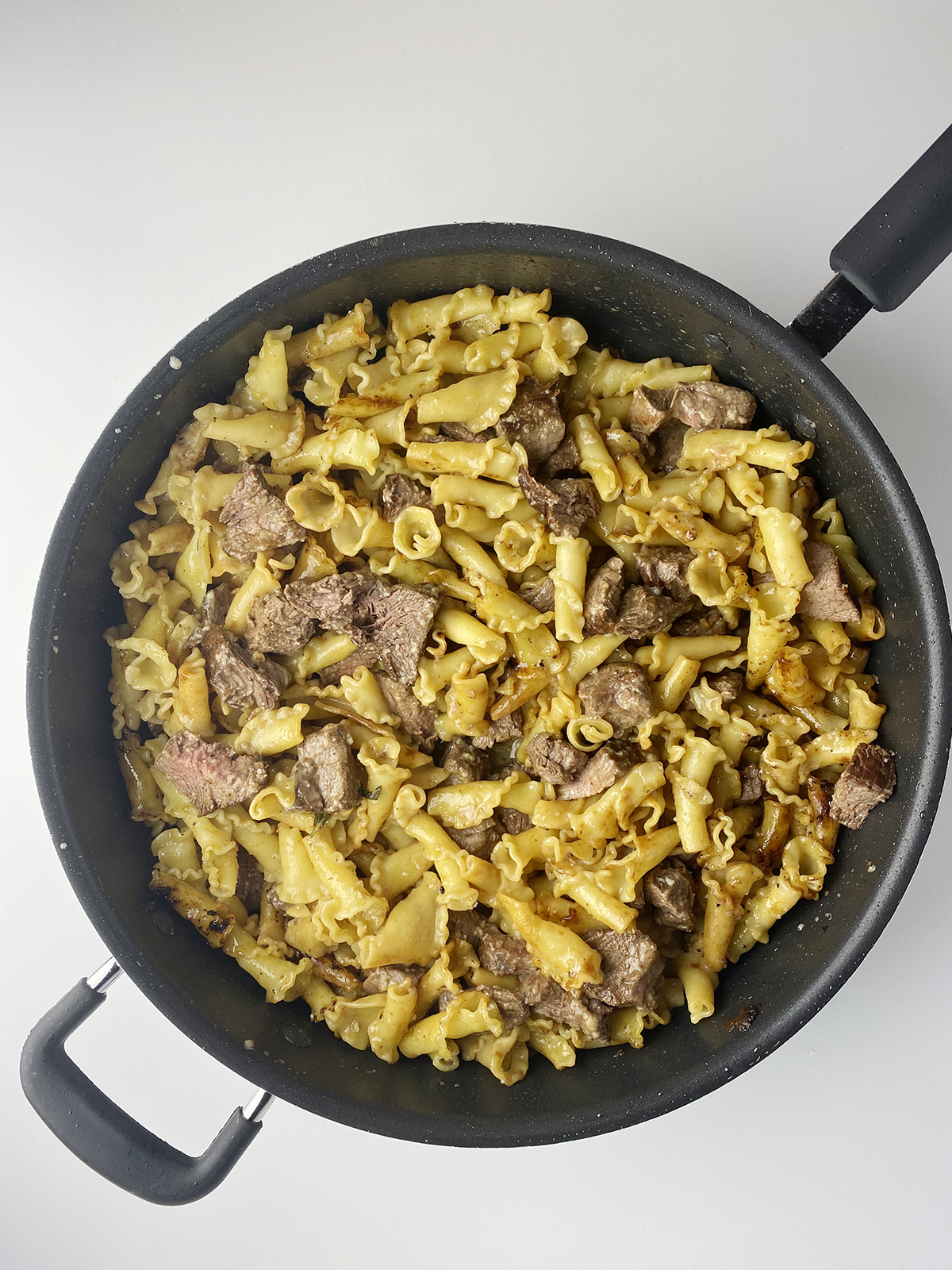 Filet mignon pasta in a skillet.