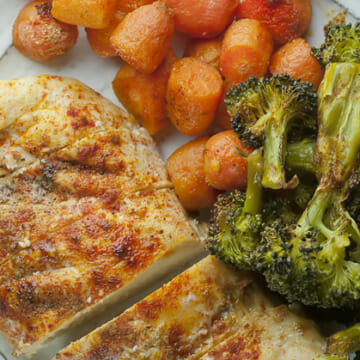 Sheet pan chicken dinner on a plate.