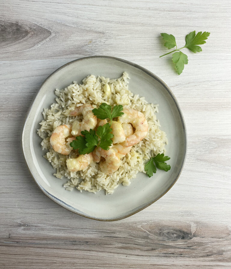 Shrimp with blue cheese sauce on a plate.
