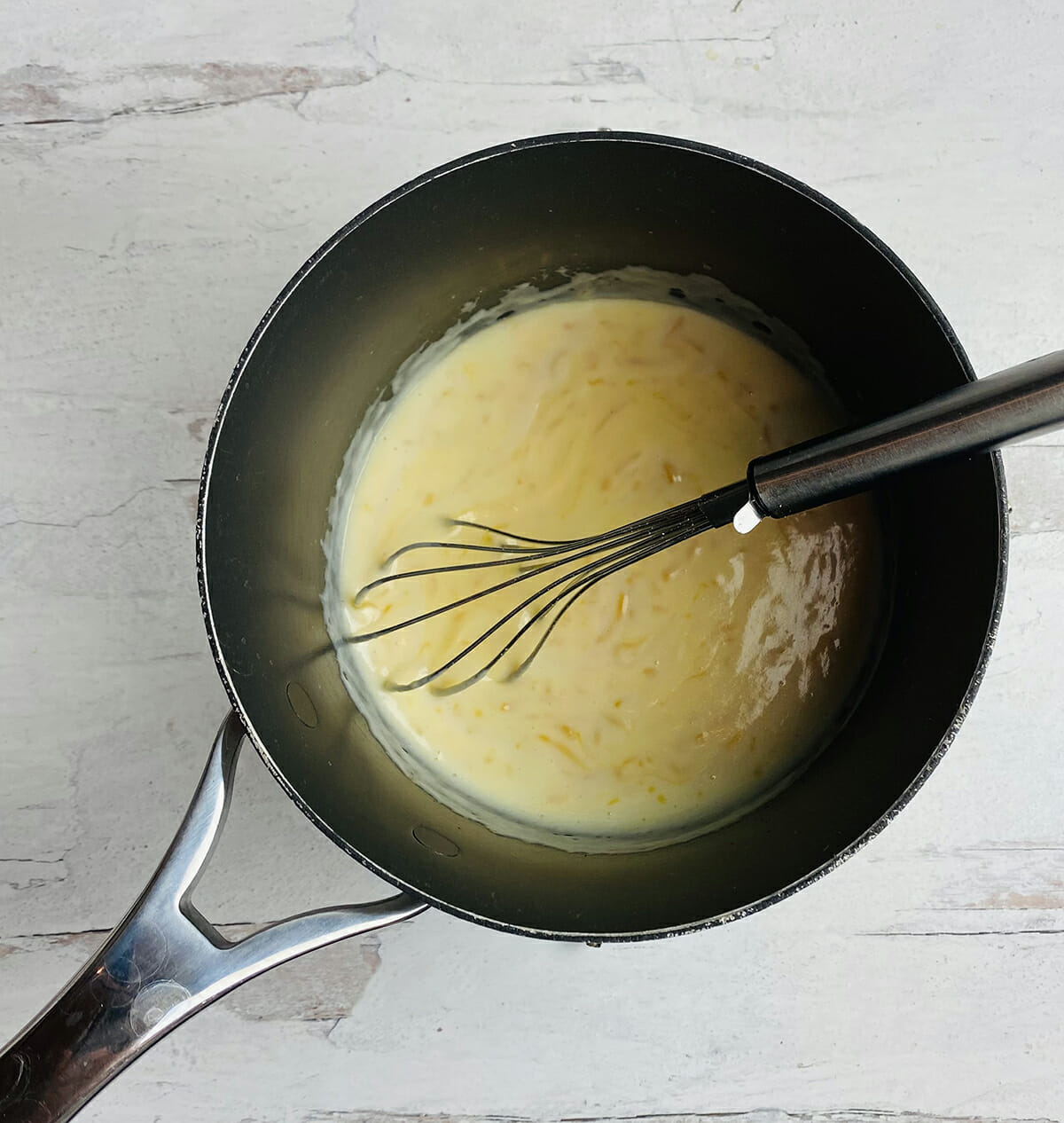 Cauliflower casserole cheese sauce in pot.