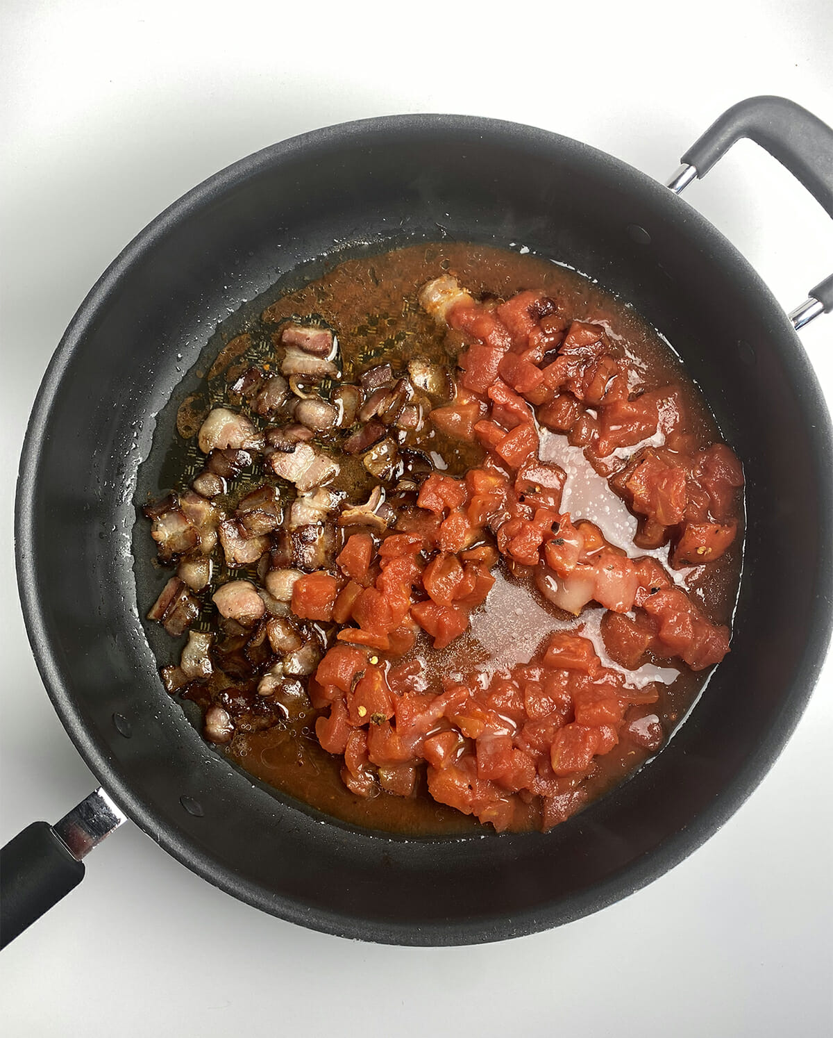 Tomato bacon sauce in a skillet.