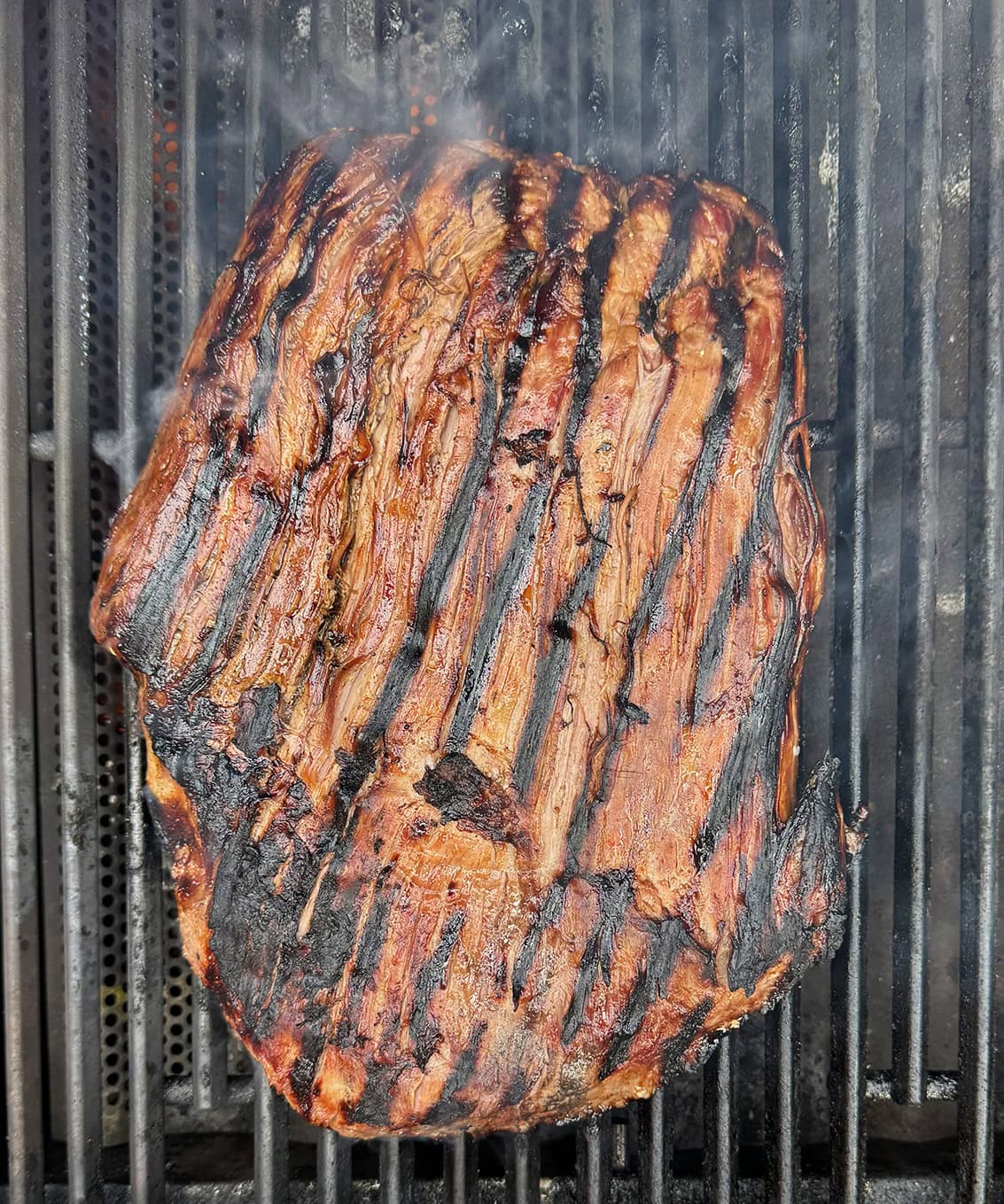 Steak cooking on the grill.