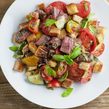 Steak panzanella salad on a plate.