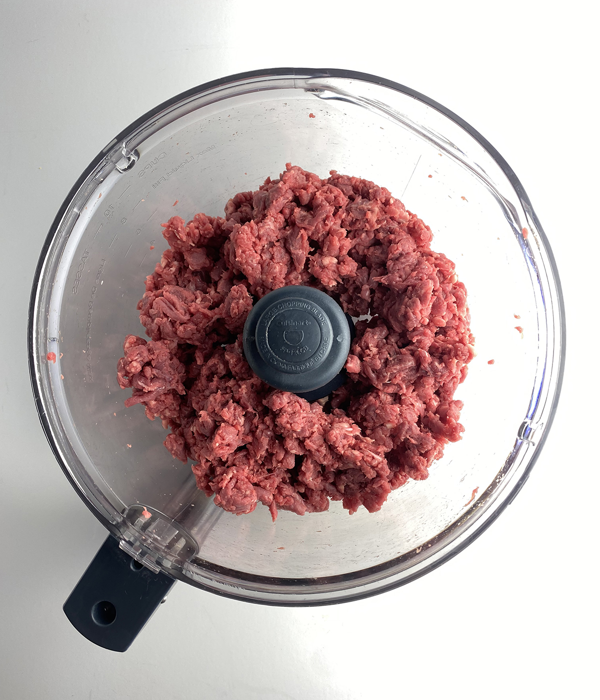 Chopped filet mignon in a food processor.
