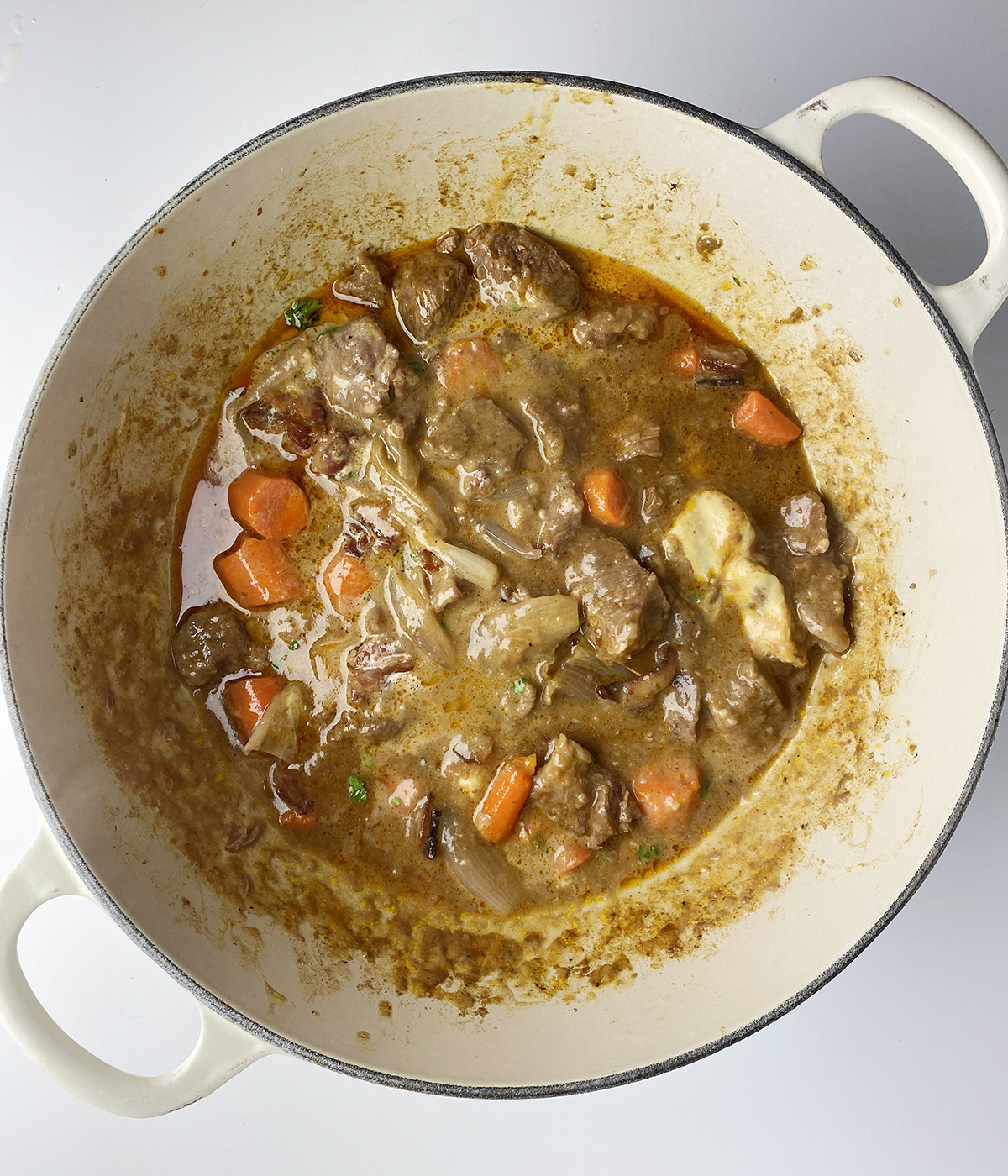 Cooked mustard beef stew in a pot.