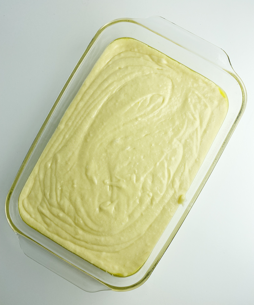 Orange juice crumb cake batter in a baking pan.