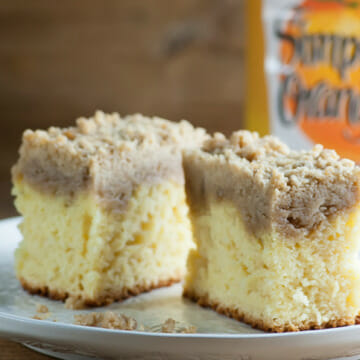 Two pieces of orange juice crumb cake on a plate.