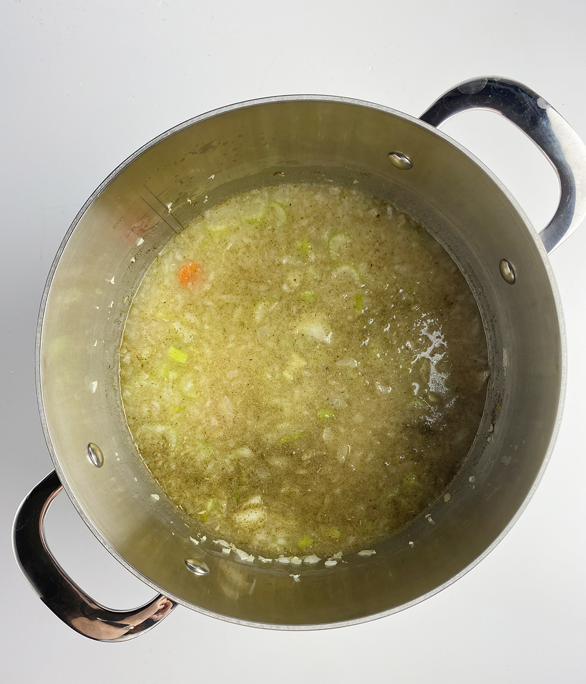 Chicken broth simmering in a pot.