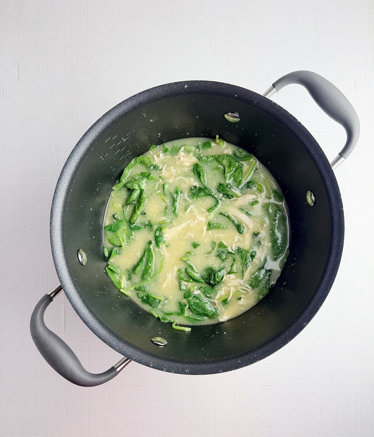 Chicken polenta soup in a pot.