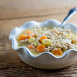 Chicken rosemary soup in a bowl.