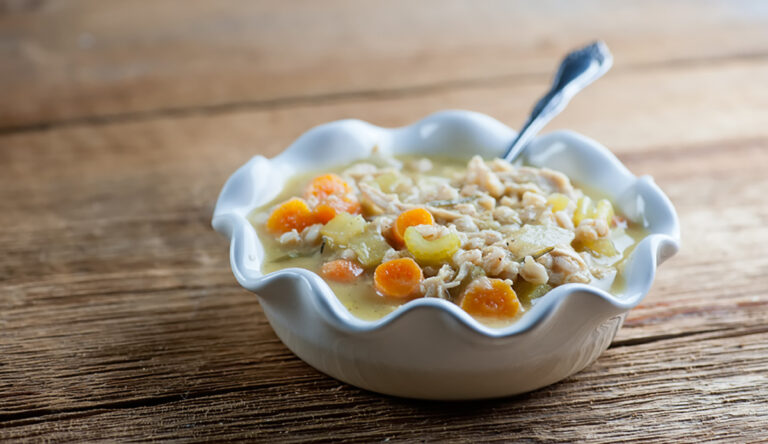Chicken rosemary soup in a bowl.