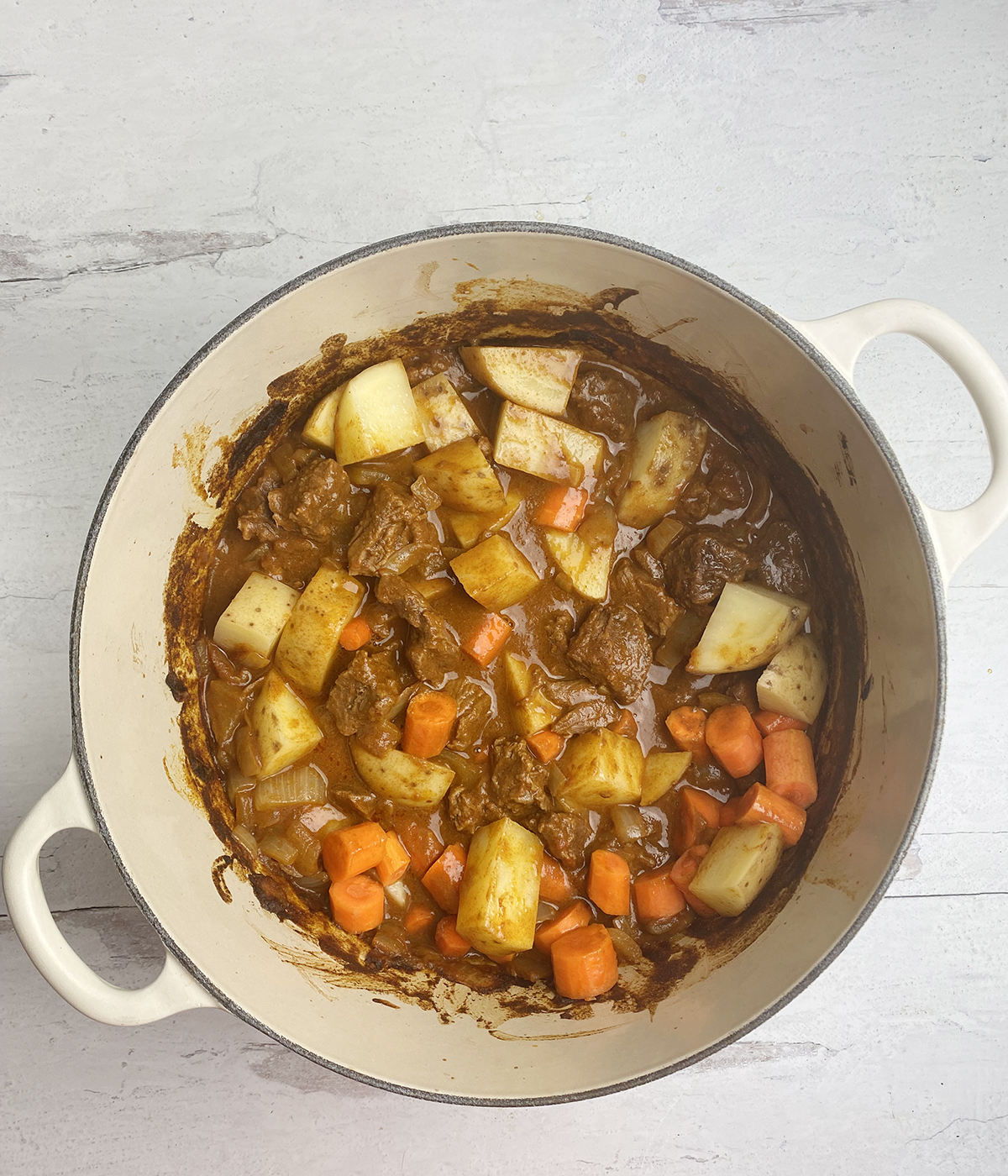 Coconut beef stew with all ingredients in a pot.