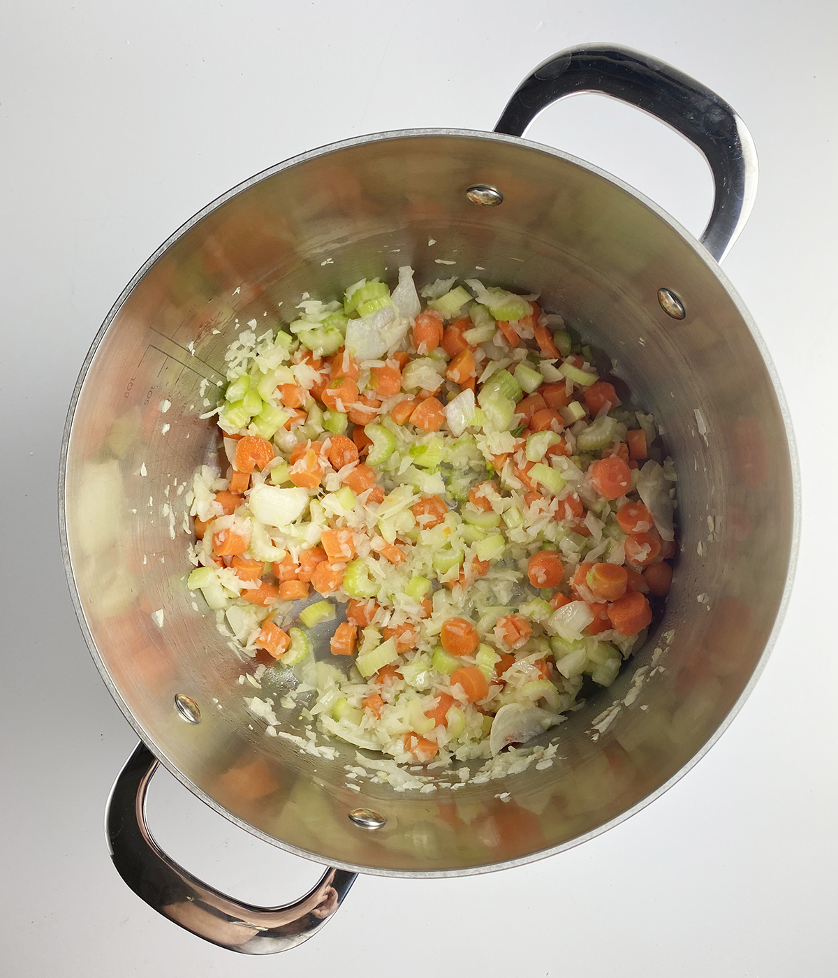 Cooked chopped vegetables in a pot.