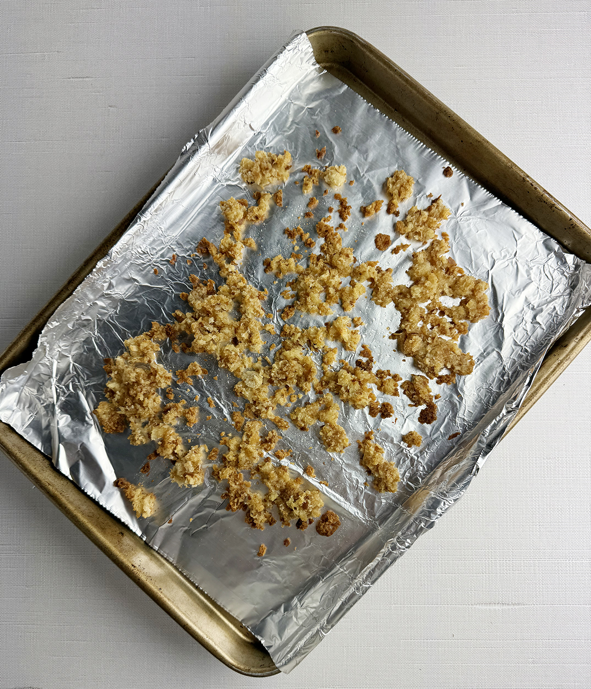 Toasted bread crumbs on a baking sheet.