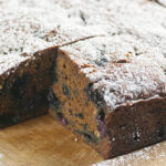 Blueberry molasses cake on a wooden board.