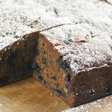 Blueberry molasses cake on a wooden board.