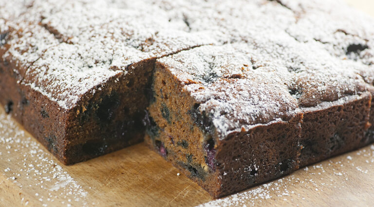 Blueberry molasses cake on a wooden board.