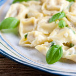 Tortellini with Basil Cream Sauce in a bowl.