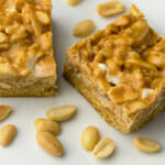 Payday cookie bars with peanuts on a counter.