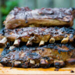 Cooked ribs on a cutting board.