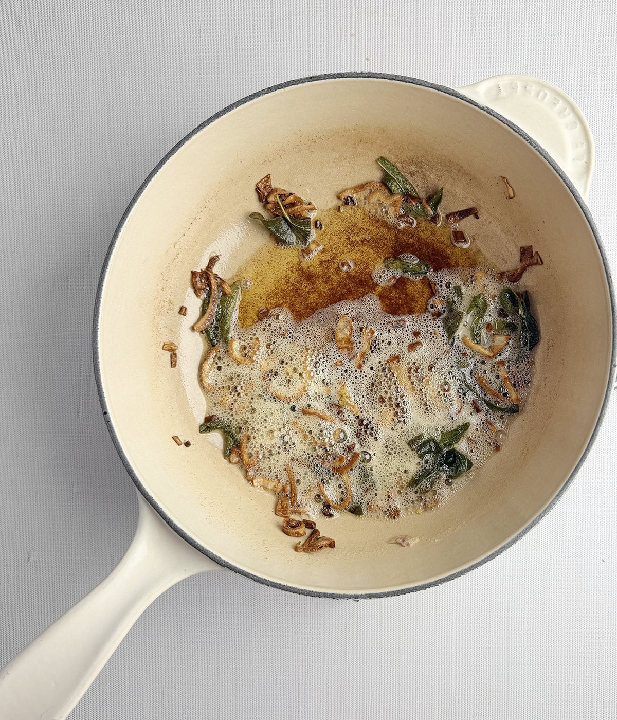 Brown butter sage sauce in a pan.