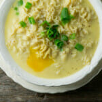 Cheesy ramen with poached egg in a bowl.