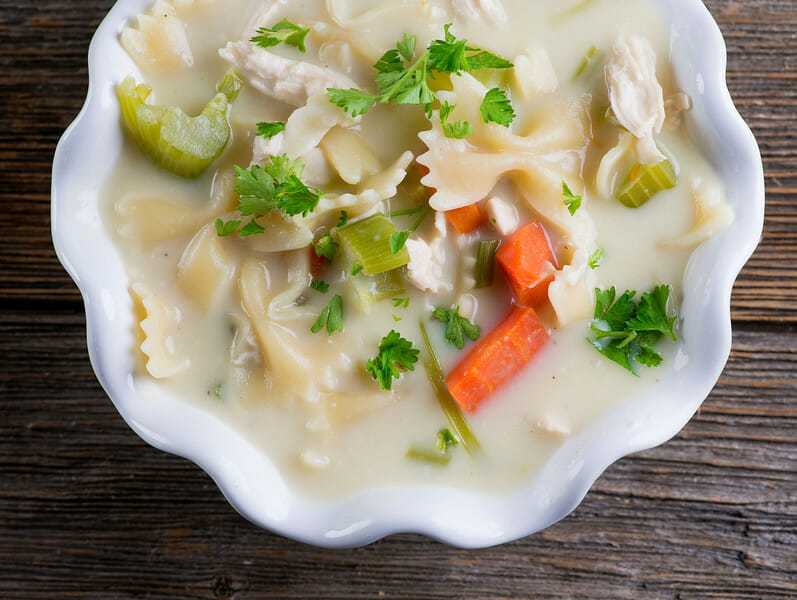 A bowl of creamy chicken noodle soup.