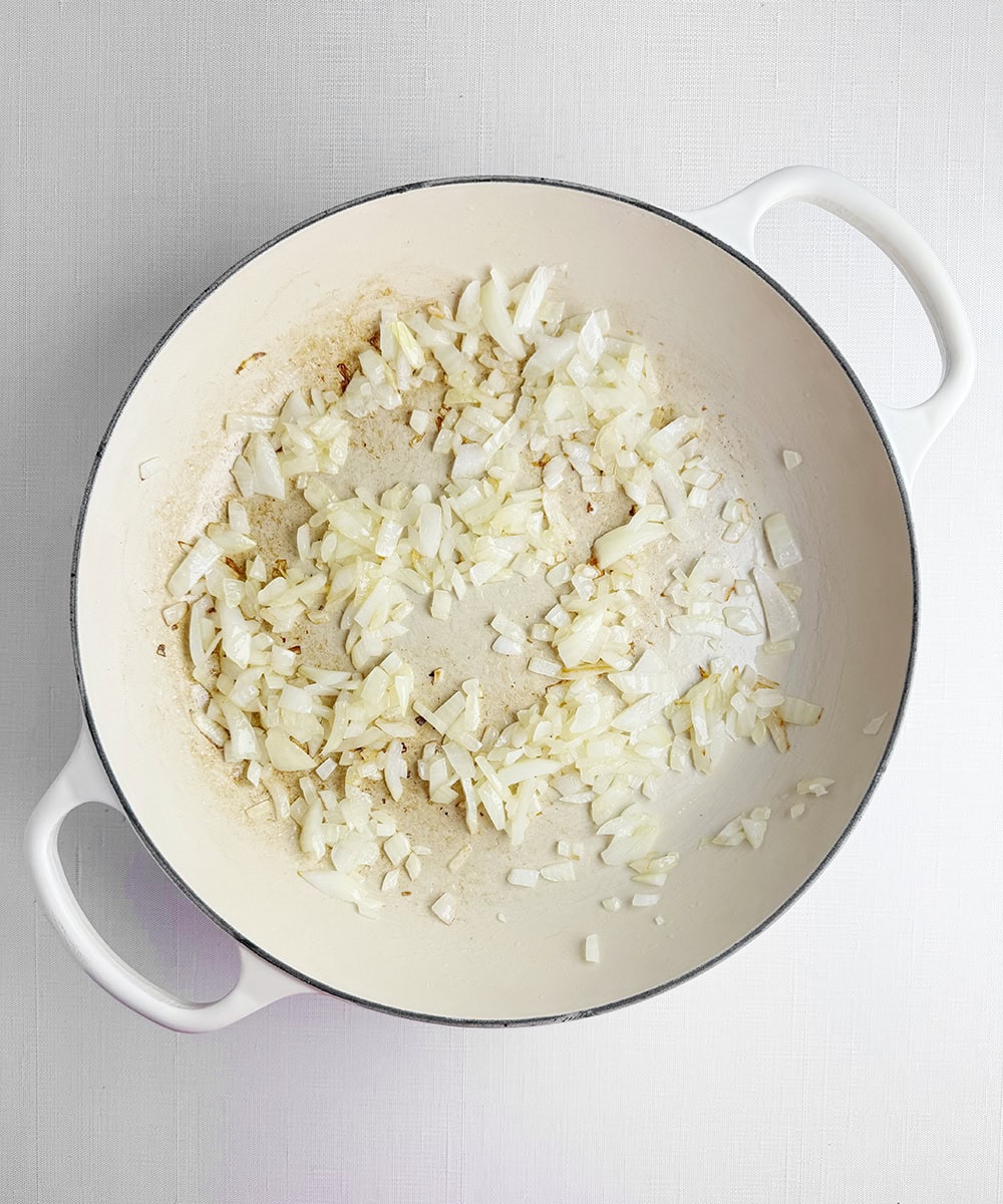Onions cooking in a pan.