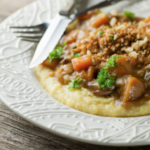 Plate of beef stew with crispy breadcrumbs.